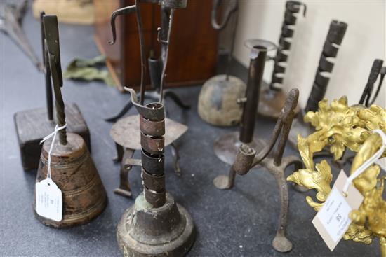 Eleven 17th century and later iron rushlight holders and candlesticks, largest 11.5in.